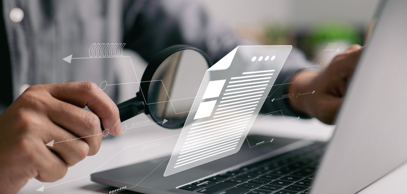 Man inspecting paperwork with magnifier. A business analysis con