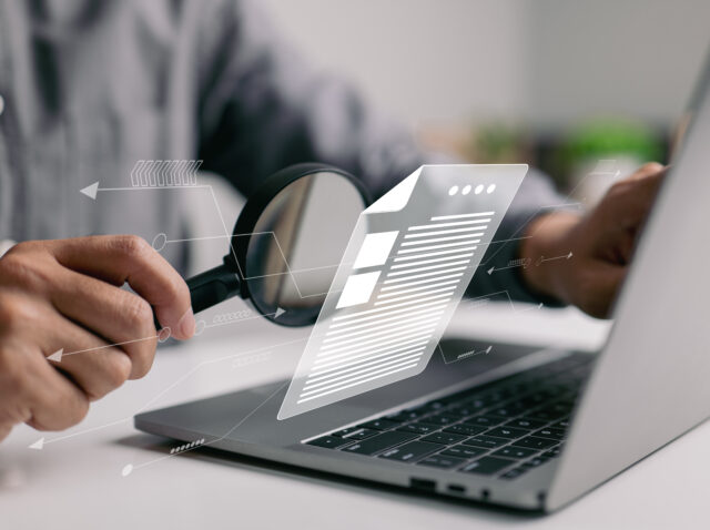 Man inspecting paperwork with magnifier. A business analysis con